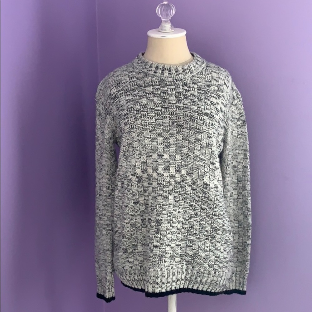 White and grey sweater with black detail.